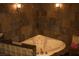 Elegant bathroom featuring a corner tub, stylish tile accents, and warm lighting at 4745 Gunlock Cir, North Las Vegas, NV 89031