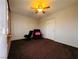 Cozy bedroom with ceiling fan, dark brown carpet, with chair and recliner at 4745 Gunlock Cir, North Las Vegas, NV 89031