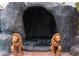 Tranquil pool grotto featuring carved lion statues, jacuzzi, and stone construction at 4745 Gunlock Cir, North Las Vegas, NV 89031