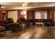 Comfortable living room features plush seating, natural light, wood-look flooring, and ceiling fan at 4745 Gunlock Cir, North Las Vegas, NV 89031