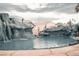 Resort-style pool with rock waterfalls, grotto, and lush landscaping create a private backyard oasis at 4745 Gunlock Cir, North Las Vegas, NV 89031