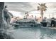 Resort-style pool with rock waterfalls, grotto, and lush landscaping create a private backyard oasis at 4745 Gunlock Cir, North Las Vegas, NV 89031