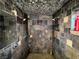 Modern shower featuring multiple showerheads, stone-tiled walls, and high-end fixtures at 4745 Gunlock Cir, North Las Vegas, NV 89031