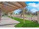 Covered back patio with view of golf course and lush green artificial grass at 5000 Forest Oaks Dr, Las Vegas, NV 89149