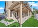 Spacious covered back patio with artificial grass and access to the home through sliding glass doors at 5000 Forest Oaks Dr, Las Vegas, NV 89149