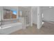 This bathroom offers a tub, shower, and bright natural light at 5000 Forest Oaks Dr, Las Vegas, NV 89149