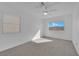 Bright bedroom features plush carpeting and windows at 5000 Forest Oaks Dr, Las Vegas, NV 89149