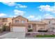 Charming two-story home featuring a tile roof, desert landscaping, and an attached two-car garage at 5000 Forest Oaks Dr, Las Vegas, NV 89149