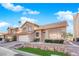 Two-story home featuring desert landscaping, an attached two-car garage, and a tile roof at 5000 Forest Oaks Dr, Las Vegas, NV 89149