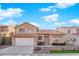 Charming two-story home featuring a tile roof, desert landscaping, and an attached two-car garage at 5000 Forest Oaks Dr, Las Vegas, NV 89149