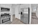 Updated kitchen with stainless steel appliances, ample cabinet space, and modern flooring at 5000 Forest Oaks Dr, Las Vegas, NV 89149