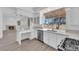 Bright kitchen with stainless steel appliances, white cabinetry, and views of the backyard at 5000 Forest Oaks Dr, Las Vegas, NV 89149