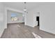 Bright, open living area featuring gray wood-look floors, white walls and trim, and modern lighting at 5000 Forest Oaks Dr, Las Vegas, NV 89149