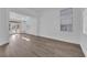 Bright, open living area featuring gray wood-look floors, white walls and trim, and large windows at 5000 Forest Oaks Dr, Las Vegas, NV 89149