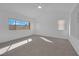 Bright main bedroom with plush carpet, ceiling fan and large windows at 5000 Forest Oaks Dr, Las Vegas, NV 89149