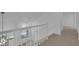 Carpeted staircase with white railing and modern lighting fixture at 5000 Forest Oaks Dr, Las Vegas, NV 89149