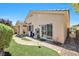 Well-maintained backyard featuring a patio area, lush lawn, and mature landscaping at 5218 Blue Gum Ct, Las Vegas, NV 89148