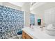 Bright bathroom featuring a vanity, toilet and shower with a floral shower-curtain at 5218 Blue Gum Ct, Las Vegas, NV 89148