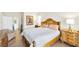 Spacious bedroom featuring a king bed, wood floors, and a doorway leading to the bath at 5218 Blue Gum Ct, Las Vegas, NV 89148