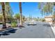 Gated community entrance with palm trees and well-maintained landscaping at 5218 Blue Gum Ct, Las Vegas, NV 89148
