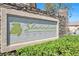 Decorative stone sign for Shadowbrook Canyon community, with lush green landscaping at 5218 Blue Gum Ct, Las Vegas, NV 89148
