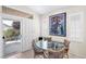 A modern dining area with a glass table set and outside access at 5218 Blue Gum Ct, Las Vegas, NV 89148