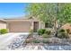Charming single-story home with well-manicured landscaping, a two-car garage, and a cozy front porch at 5218 Blue Gum Ct, Las Vegas, NV 89148