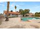 Rear exterior of home and expansive backyard with a pool and spa at 5248 W Lake Mead Blvd, Las Vegas, NV 89108