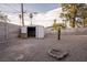 Spacious backyard featuring gravel, block walls, a palm tree, shed, and a fire pit at 5408 Longridge Ave, Las Vegas, NV 89146