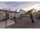 Cozy backyard featuring gravel, a small palm tree, patio, and a built-in outdoor kitchen at 5408 Longridge Ave, Las Vegas, NV 89146