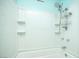 Bathroom showing a white tiled shower and tub with built-in shelving at 5408 Longridge Ave, Las Vegas, NV 89146
