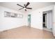 Well-lit bedroom with tiled flooring, large window, and a ceiling fan at 5408 Longridge Ave, Las Vegas, NV 89146