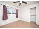 Bedroom showcasing neutral-toned tile floors, a ceiling fan, and a closet at 5408 Longridge Ave, Las Vegas, NV 89146