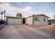 Single-story home featuring an attached garage and desert landscaping at 5408 Longridge Ave, Las Vegas, NV 89146
