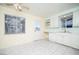 Kitchen area featuring white cabinetry, tiled flooring, and functional appliances at 5408 Longridge Ave, Las Vegas, NV 89146