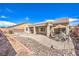 Wide backyard with stone landscaping, covered patio and space for Gathering entertaining at 5525 Criollo Dr, Las Vegas, NV 89122