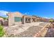 Serene backyard with covered patio and a mix of rock and concrete landscaping at 5525 Criollo Dr, Las Vegas, NV 89122