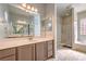 This primary bathroom features a dual sink vanity with tile floors and a shower at 5525 Criollo Dr, Las Vegas, NV 89122