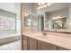 Bathroom featuring tile flooring, shower, and a vanity with dual mirrors at 5525 Criollo Dr, Las Vegas, NV 89122