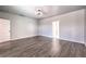 Spacious bedroom featuring wood floors, modern lighting, and two entry doors at 5525 Criollo Dr, Las Vegas, NV 89122