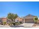 Beautiful single-story home with manicured desert landscaping and a two-car garage at 5525 Criollo Dr, Las Vegas, NV 89122