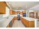 Well-lit kitchen offers tile floors, light wood cabinets, and an island with seating at 5525 Criollo Dr, Las Vegas, NV 89122