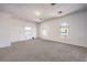 Bright living room features neutral carpet and three windows letting in natural light at 5525 Criollo Dr, Las Vegas, NV 89122