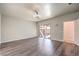 An open living room with wood floors, a sliding glass door, and modern lighting at 5525 Criollo Dr, Las Vegas, NV 89122