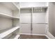 Spacious walk-in closet with white shelving and wood flooring, for optimal storage at 5525 Criollo Dr, Las Vegas, NV 89122