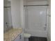 White tiled bathroom with granite counter top and tub/shower combination at 5642 Sunset Amber Ave, Las Vegas, NV 89122