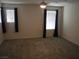 Carpeted bedroom with ample natural light from two windows with black curtains, and ceiling fan at 5642 Sunset Amber Ave, Las Vegas, NV 89122