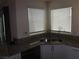 Kitchen featuring a stainless steel sink, granite countertops, and bright windows at 5642 Sunset Amber Ave, Las Vegas, NV 89122