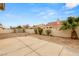 Expansive backyard features a concrete patio, desert landscaping, and mature palm tree at 6209 Lenaking Ave, Las Vegas, NV 89122