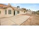 Charming backyard with concrete patio, desert landscaping, and stucco exterior of the home at 6209 Lenaking Ave, Las Vegas, NV 89122